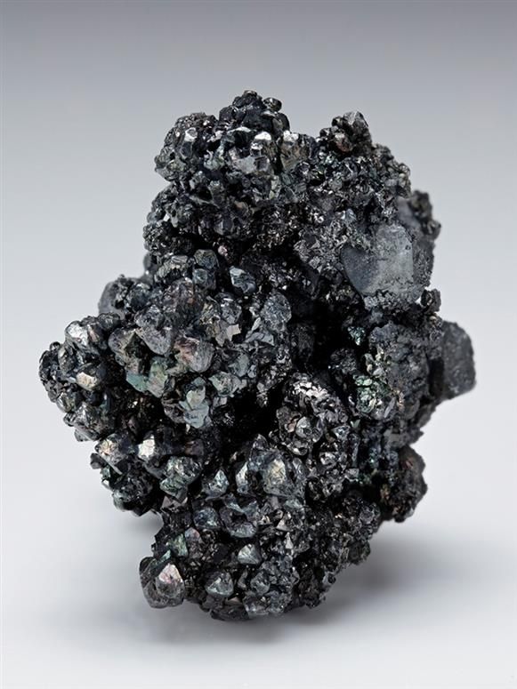 Acanthite with Polybasite, Freiberg District, Erzgebirge, Saxony, Germany. A neat silver mineral specimen displaying a somewhat arborescent-like form with abundant intergrown crystals of metallic grey Acanthite crystals measuring to 6mm, with some iridescence, associated with rare platy groups of Polybasite. Size 4.3 × 3.5 × 2.5 cm