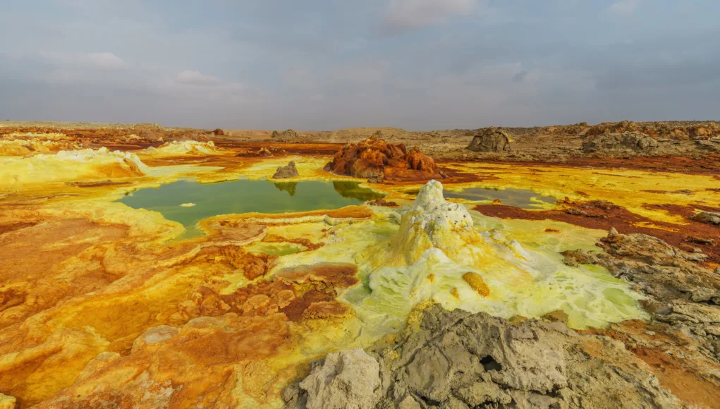 Acidic pools and mineral terraces in Dallol, Ethiopia, where extreme heat and sulfur-rich waters create one of Earth’s most alien volcanic landscapes.