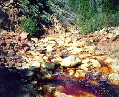 Acid mine drainage produced by oxidation of pyrite in mine rocks